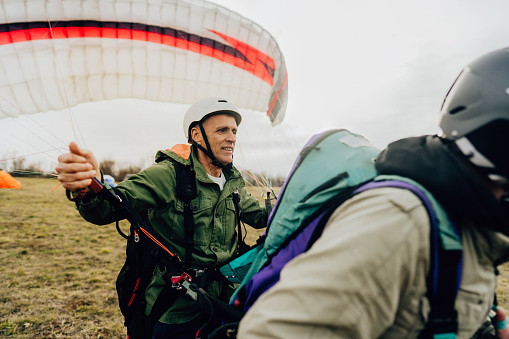 Photo of a smiling senior man getting ready to take off with his instructor