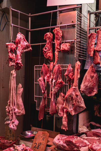 istock Hanging pork and meat at butcher shop 1211363448