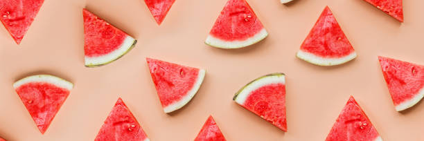 istock Creative flat lay top view of fresh watermelon slices on orange table background with copy space. Minimal summer fruits pattern for blog or recipe book. Healthy food and diet concept 1211363529