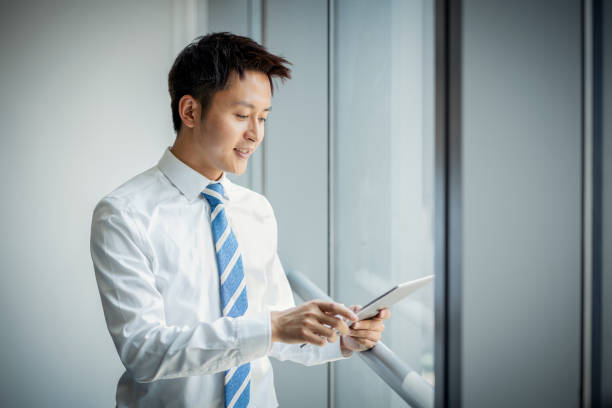 istock Beautiful business man Texting in the office 1211363584