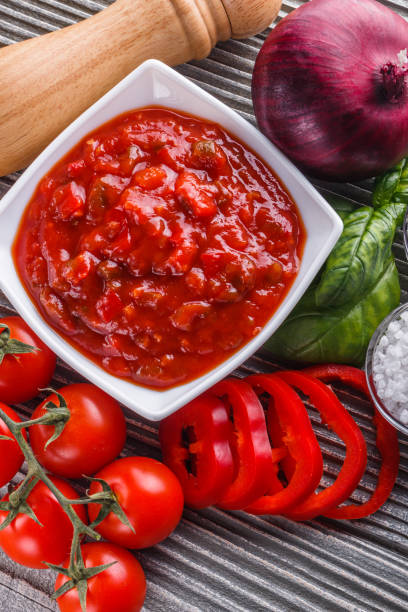 istock Fresh tasty tomato sauce on rustic wooden background 1211363691
