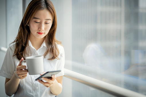 Young businesswoman using a smartphone in office