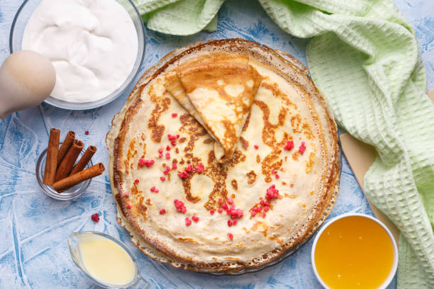 istock Delicious Russian pancakes with sour cream and honey cooked 1211363733