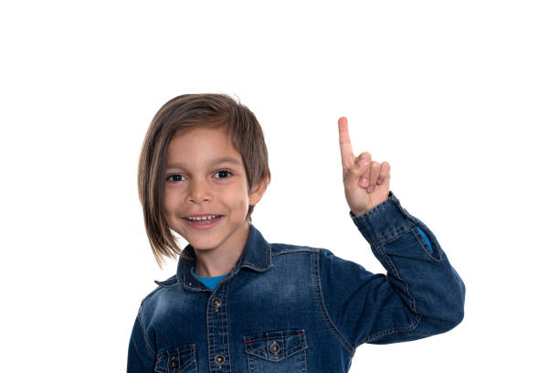 istock Little boy looking at camera and pointing with hand 1211363735