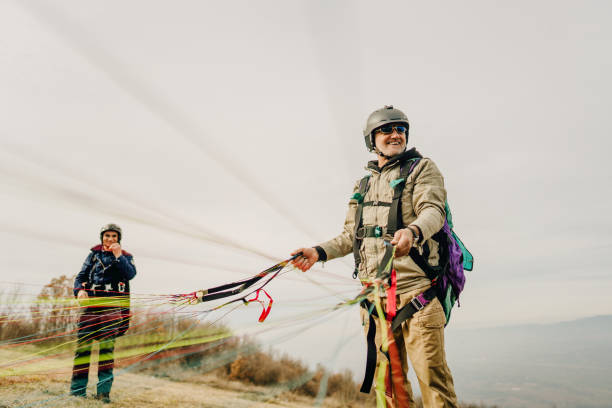 istock Senior man packing up his parachute 1211364628
