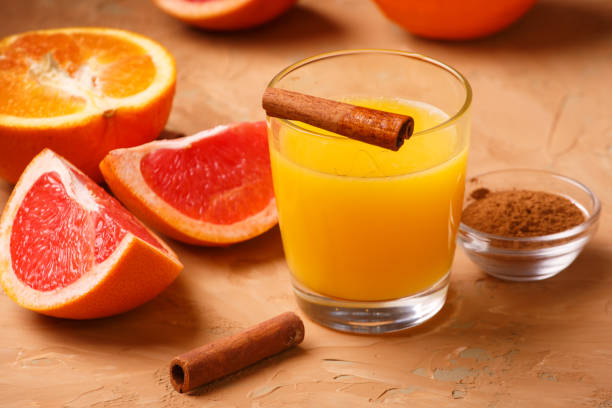 Organic foods orange, grapefruit, juice and aromatic cinnamon - fotografia de stock