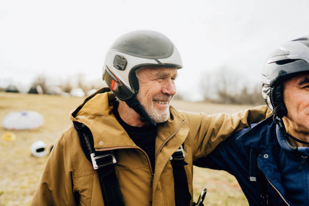 istock Old friends getting ready for the flight with a paraglider 1211364764