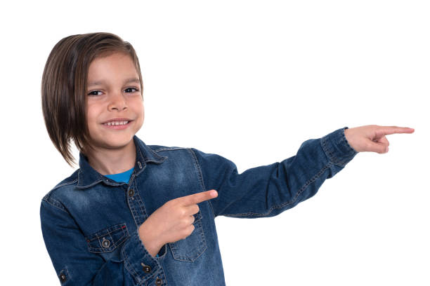 istock Little boy looking at camera and pointing with hand 1211364805