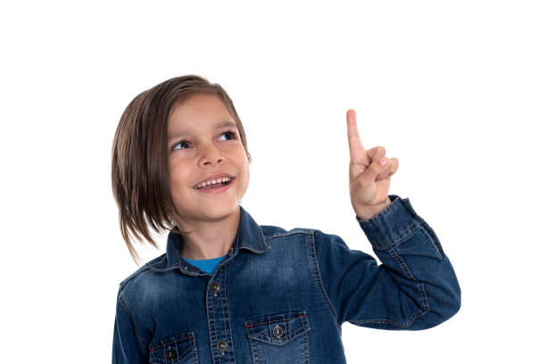 Little boy looking up and pointing with hand
