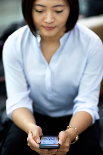 istock Businesswoman using smart phone in airport 1211368301