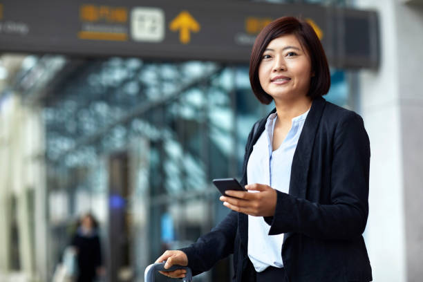 istock Entrepreneur using phone while arriving at airport 1211368358