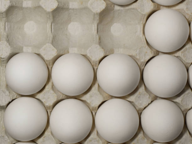 istock Raw chicken eggs in an egg field with empty seats. 1211368460