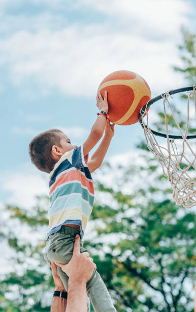 istock Father and son playing basketball 1211369940