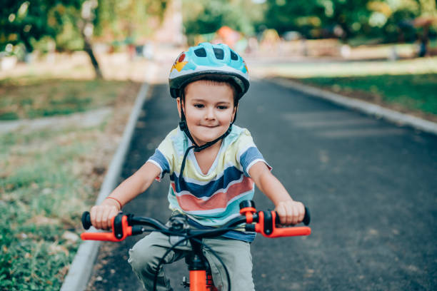 istock Cheerful little boy riding bicycle in the park. 1211369948