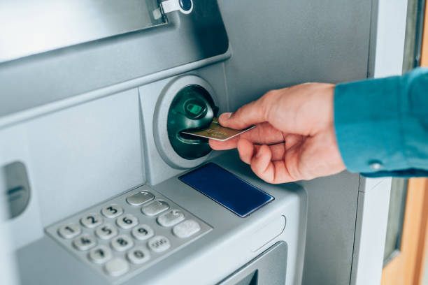 istock Man is withdrawing money from an ATM. 1211369956