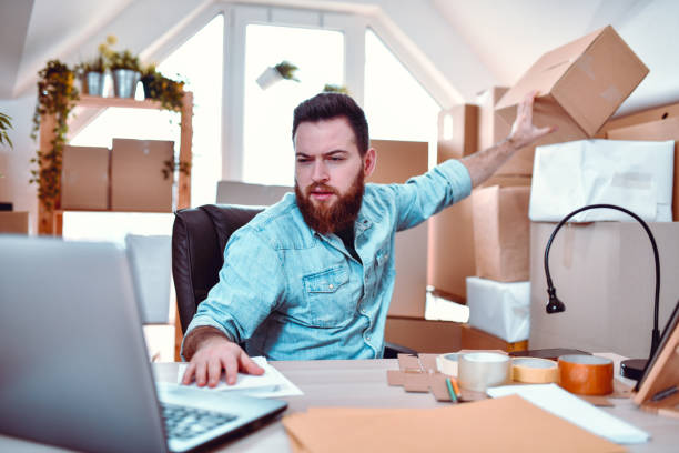 istock Male Checking If Packages That Arrived Are The Same As Listed On Laptop 1211371626