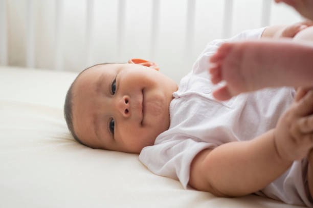 istock 6 month old baby boy is lying in his crib looking sideways 1211372242