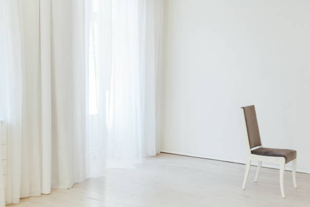 istock gray chair stands alone in the white room 1211372396