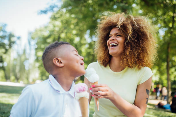 istock Boy sharing ice cream with his mom and having fun 1211373753