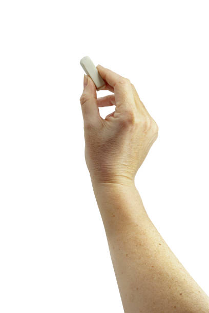 istock Woman's elegant hand holding eraser on isolated white background. Series 1/3 1211374322