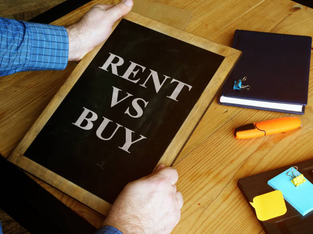 istock Rent vs Buy typed on the small blackboard. 1211374659