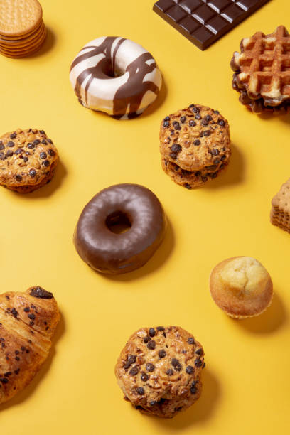 istock Sweet food pattern on a yellow paper background 1211376021