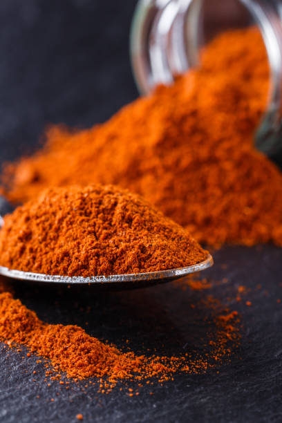 istock aromatic spicy chilli powder on a dark stone background 1211377364