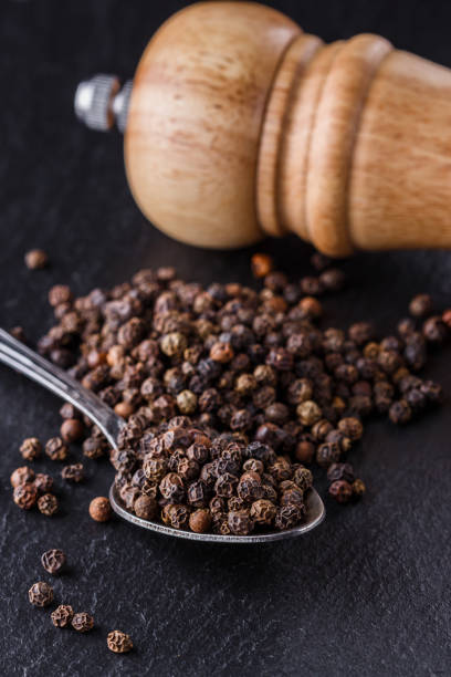 istock aromatic black pepper on a dark stone background 1211379405