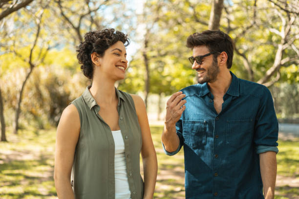 istock Young couple dating in the park 1211381407