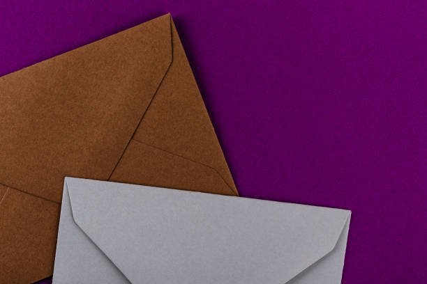 istock Colorful envelopes on a purple background. 1211382725