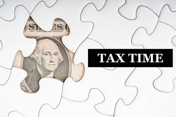 istock TAX TIME text with Dollar banknotes on white jigsaw puzzle 1211384686