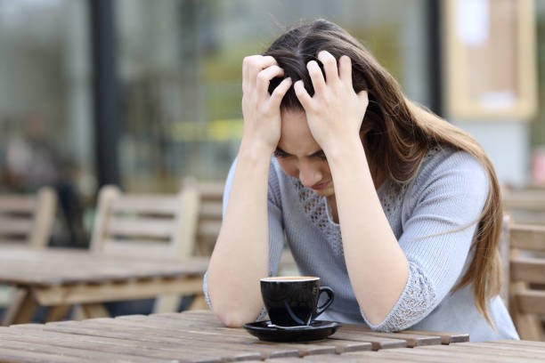 istock Sad woman complaining alone on a coffee shop terrace 1211384769