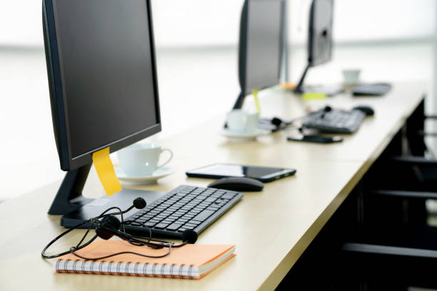 istock Chairs computers and headset call center in modern office 1211384907