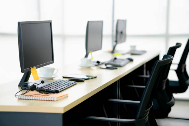istock Chairs computers and headset call center in modern office 1211385347