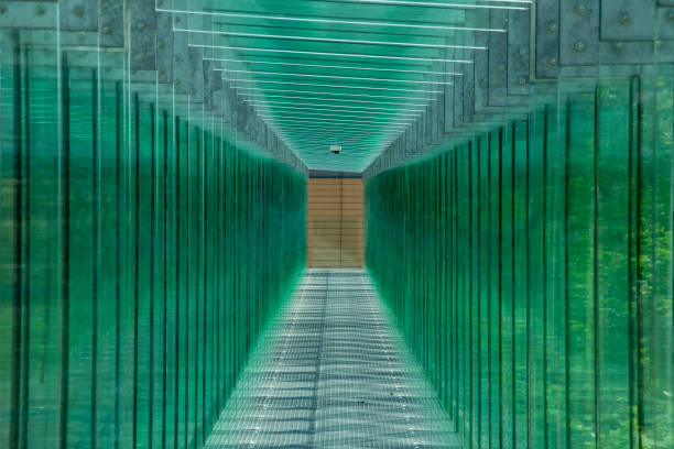 Long straight modern passage with glass walls and roof.