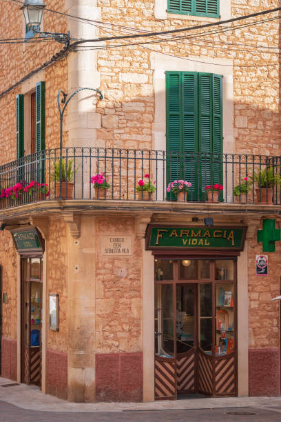 Beautiful facade of old farmacia vidal munar building in Santanyi on the balearic island of Majorca (Mallorca), Spain Santani, Spain - May 23, 2019: Beautiful facade of old farmacia vidal munar building in Santanyi on the balearic island of Majorca (Mallorca), Spain farmacia stock pictures, royalty-free photos & images