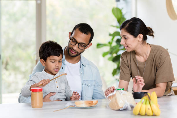 istock Independent young boy prepares sandwich 1211388270