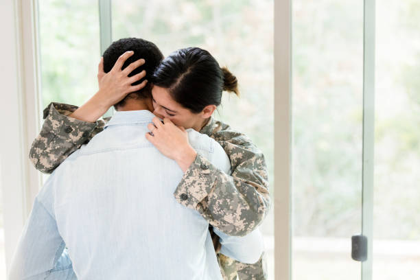 istock Upset female soldier embraces her husband 1211388278