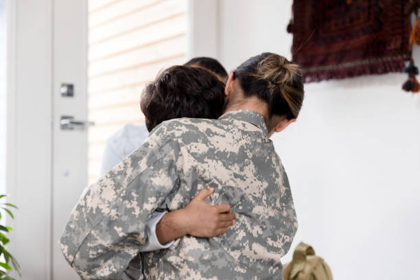 istock Female soldier hugging young son 1211388294