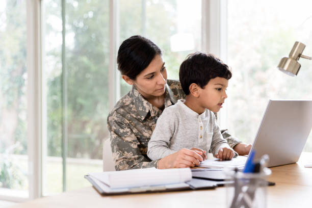 istock Little boy uses laptop with his mom 1211388301