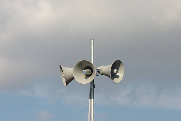 istock mast with three loudspeakers against a cloudy sky 1211388874