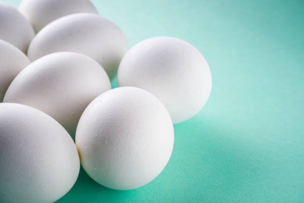 istock white chicken eggs on green pastel background 1211389107