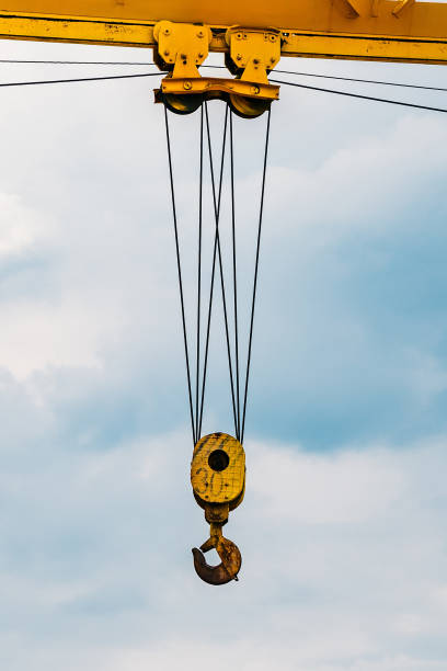 istock Crane hook against blue sky, Close up 1211389761