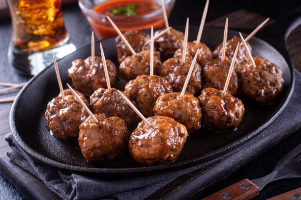 Sweet and Spicy Meatballs A platter of delicious sweet and spicy meatballs. meatball stock pictures, royalty-free photos & images