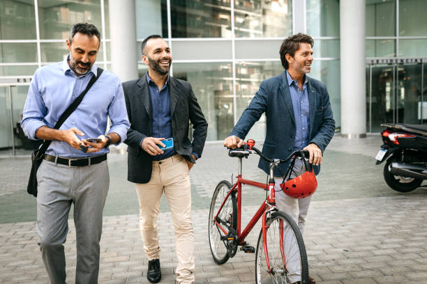 istock Business partners walking home with bicycle from work 1211393178