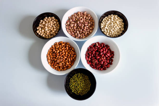 Phaseolus. Bright multi-colored beans, mung beans and chickpeas in ceramic cups. A complete source of vegetable protein in vegetarianism. The concept is healthy eating.