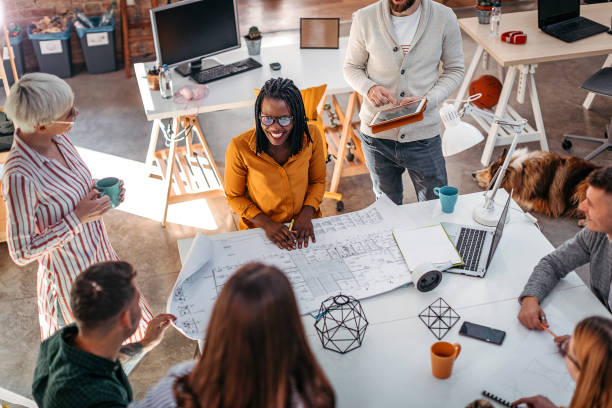 istock Business colleagues analyzing blueprint at office 1211394434
