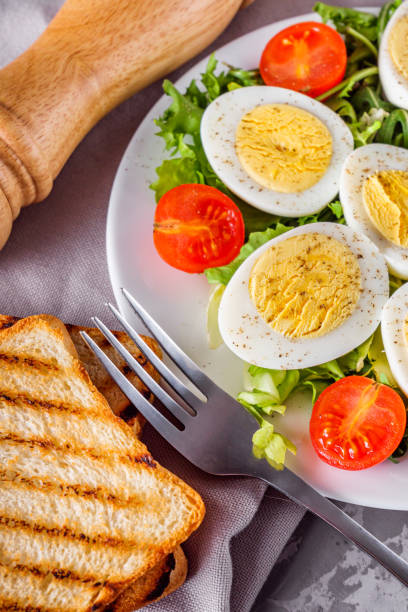 istock salad with boiled chicken eggs and cherry tomatoes on a stone background 1211396528