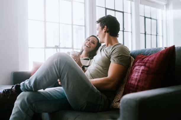 istock Happy Young Couple Relax at Home With Coffee 1211402894