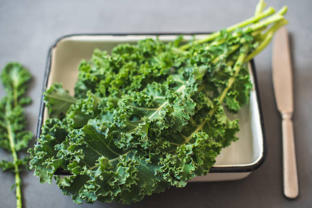 istock Green Organic healthy fresh Kale or leaf cabbage in a white enameled container 1211402923